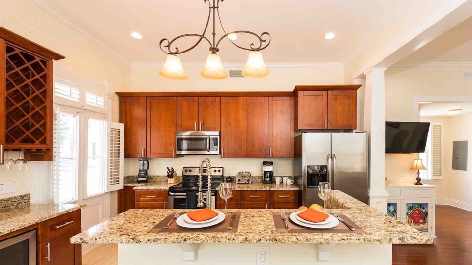 The kitchen has stainless steel appliances and expansive granite countertops...
