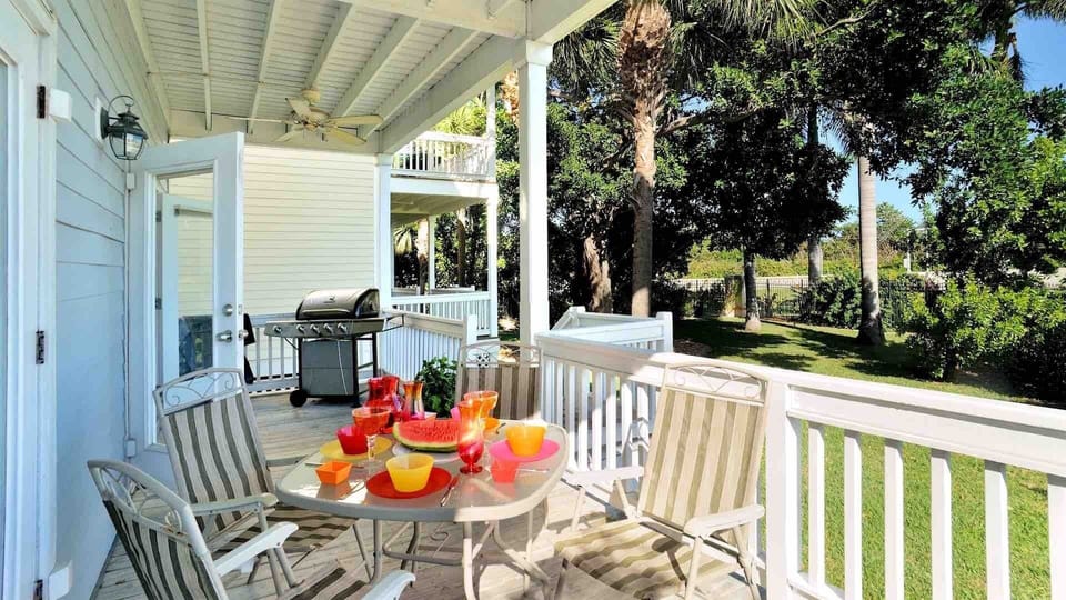 The covered back porch offers a BBQ grill and outdoor dining set...