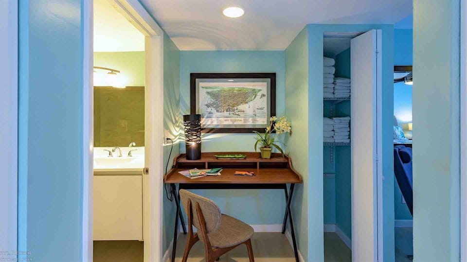 The master bedroom is located at the end of the hall and includes a small desk if you need to do some work...