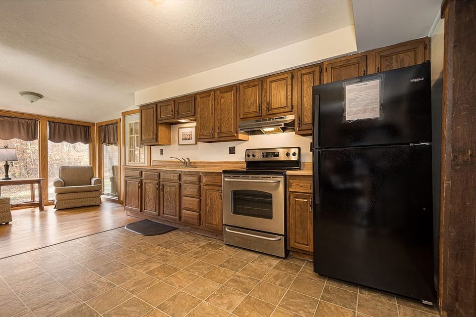 Kitchen - Main Level. Cozy kitchen with modern refrigerator, oven, microwave and gas stove.