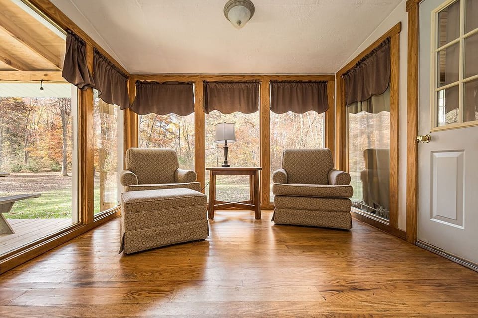 Sitting Area - Main Level. Sitting area off the kitchen with 2 chairs, surrounding view of the outside.