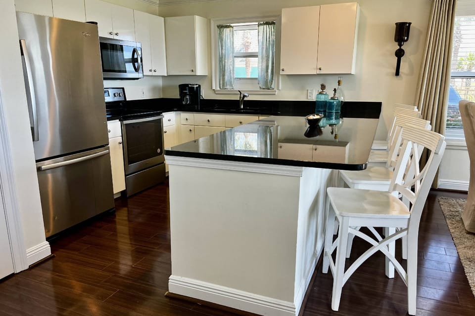 Great Fully Stocked Kitchen overlooking Dining Area & Living Room