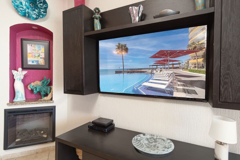 The large wall mounted TV in the living room.