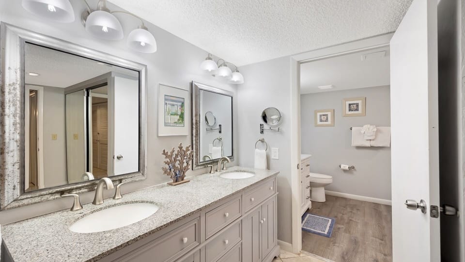 The first room of the master bathroom has a large double vanity and sinks...