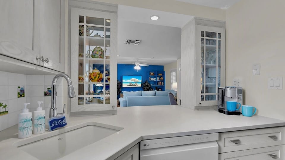 Your gourmet kitchen features pristine white cabinetry, gleaming countertops, and modern appliances that make cooking a joy.