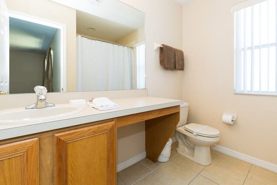Clean and functional bathroom with a large vanity area.