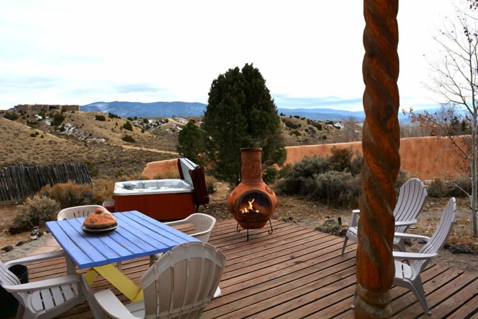 Outdoor deck overlooks hot tub and acres of awe-inspiring mesa & mountain views
