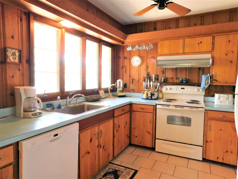 29554 N. Duneway - Cotton Patch East - Wood Finish Kitchen - A closer view of the kitchen's warm wood cabinetry, countertops, and white appliances in a bright and functional space.