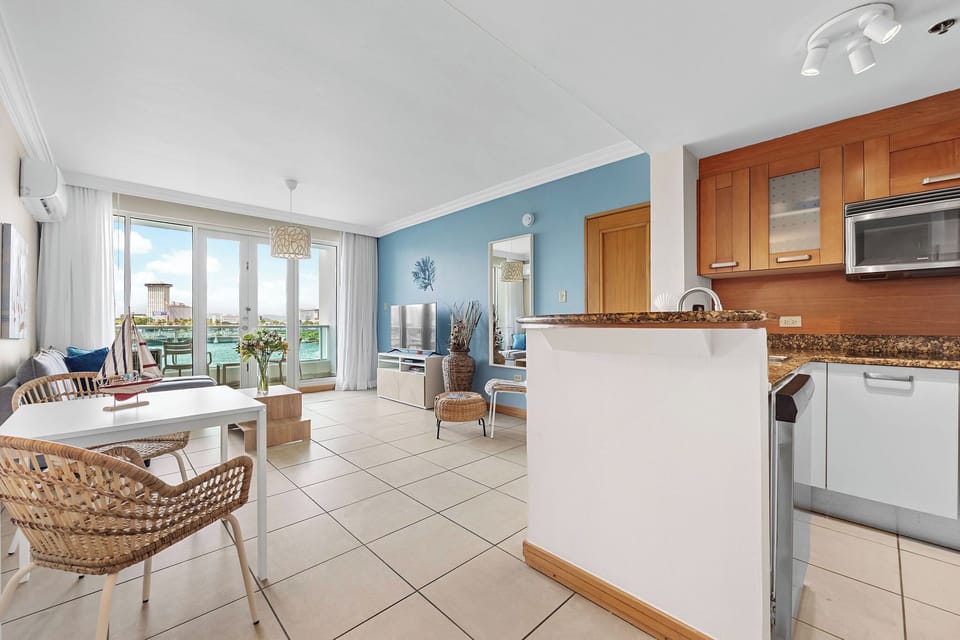 The apartment has a fully equipped kitchen and a dining table for two.