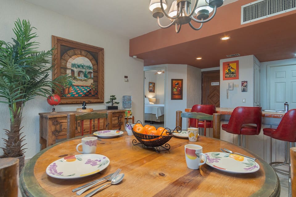The central dining table by the kitchen bar stools.