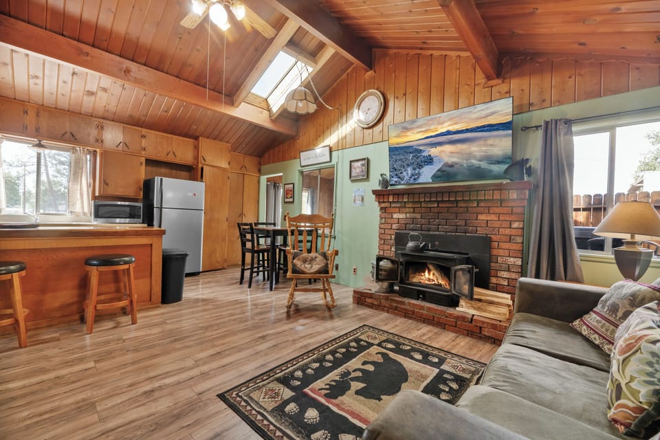 Living Room - Living Room with TV, wood burning fireplace, comfy couches, firestick TV, vaulted ceilings, and sky lights.