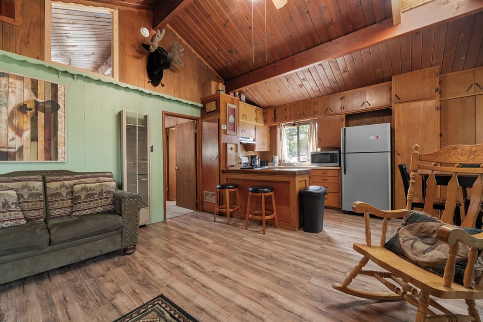 Living Room - Living Room with TV, wood burning fireplace, comfy couches, firestick TV, vaulted ceilings, and sky lights.