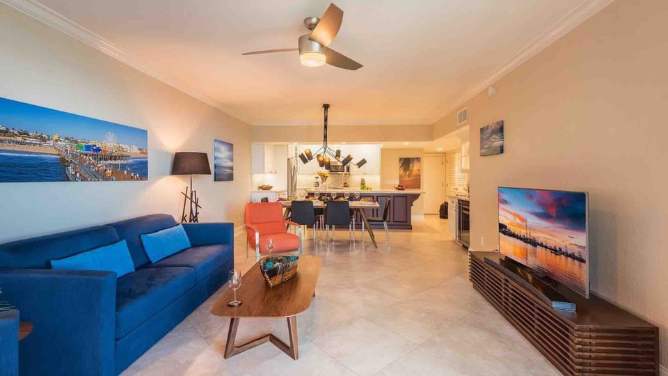 There is a large flat screen TV and comfortable couches in the living room...