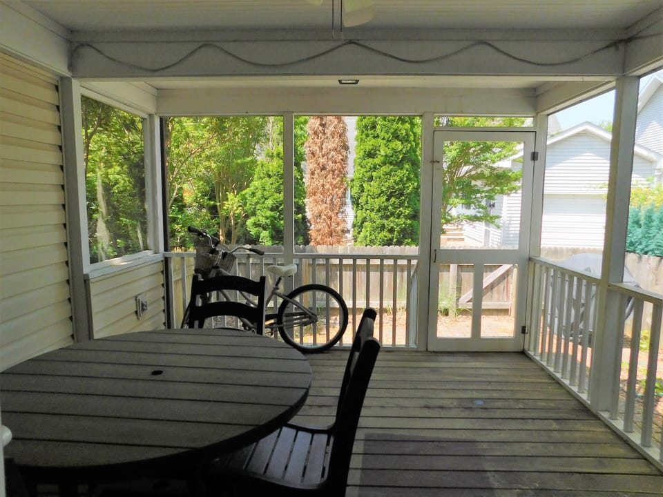 414 Bethany Pines, Bethany Beach - porch - Outdoor living space featuring a screened-in porch with a dining set and views of the surrounding trees.