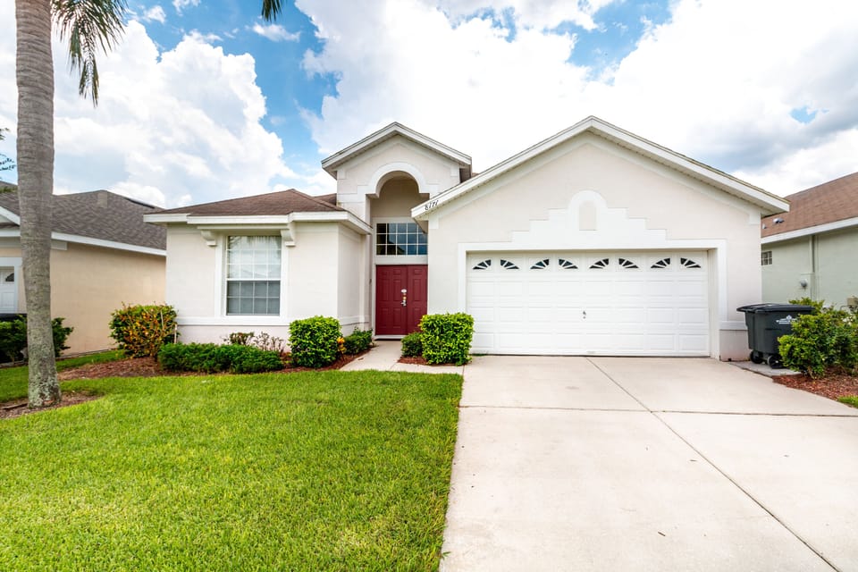 Beautiful single-family home with a well-maintained lawn and ample driveway parking.