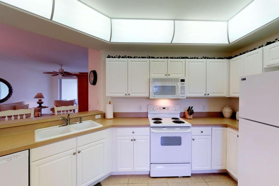 The spacious and open pass thru kitchen is equipped with all the appliances, dinnerware, cutlery, etc. needed to prepare and serve meals.