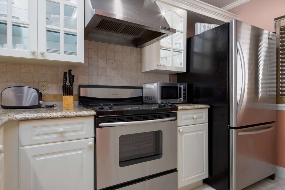 Fully stocked kitchen with stainless steel appliances and granite counters