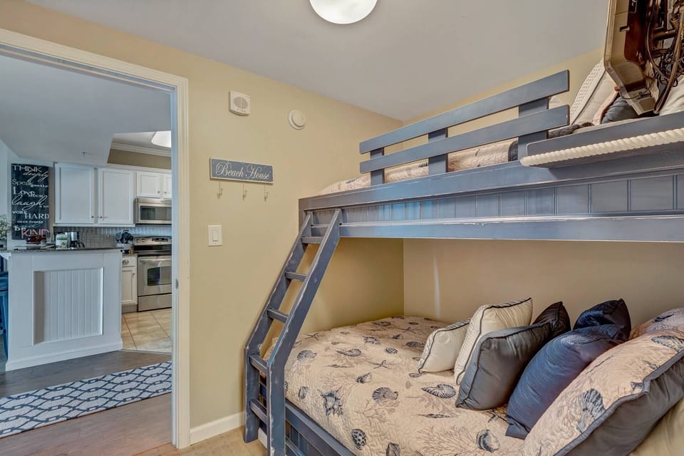 Guest room with beachy decor looking into the kitchen