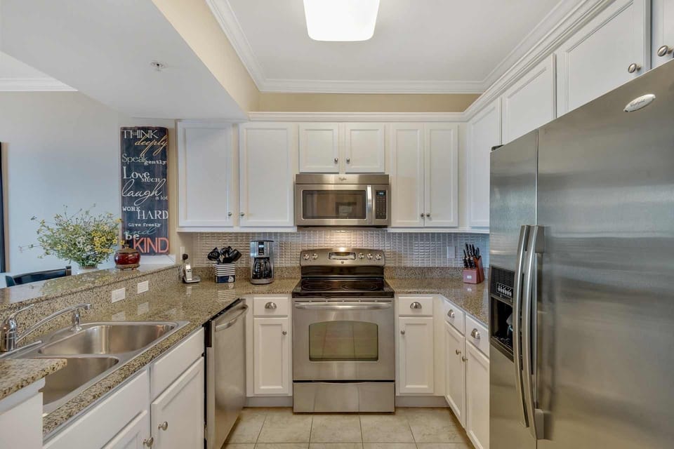 Fully-equipped kitchen with stainless steel appliances, granite counters, tile backsplash