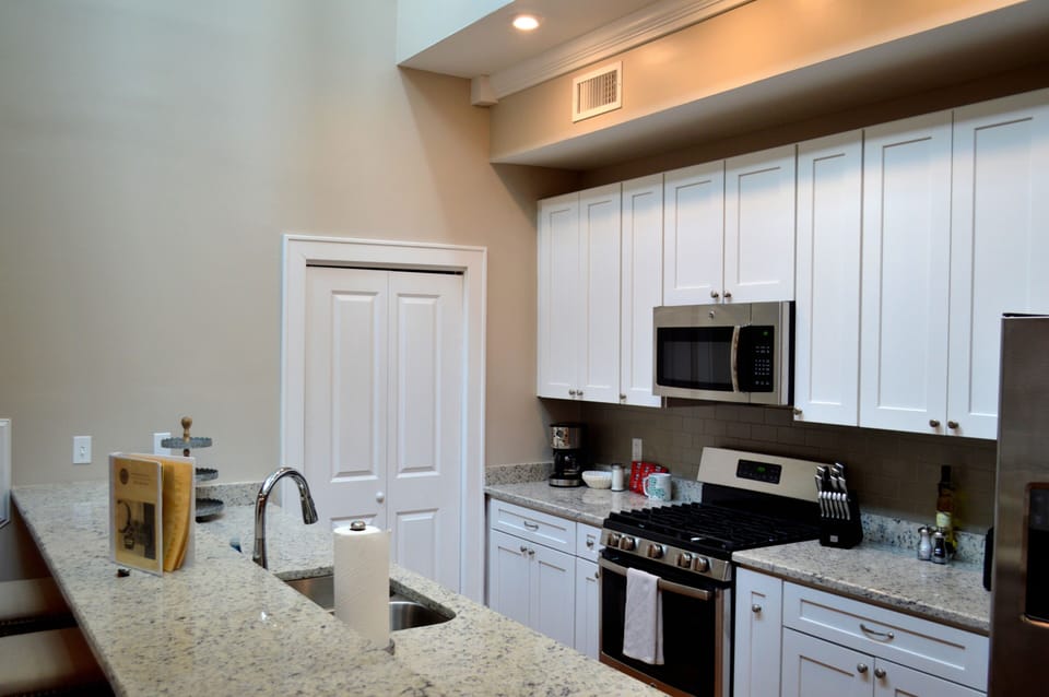 Galley style kitchen with laundry room beyond closet door