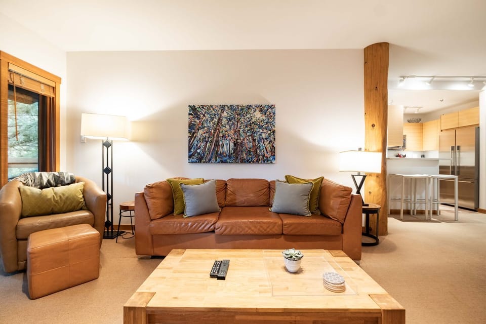 Living area: Wood burning fireplace, TV, balcony access, forest view