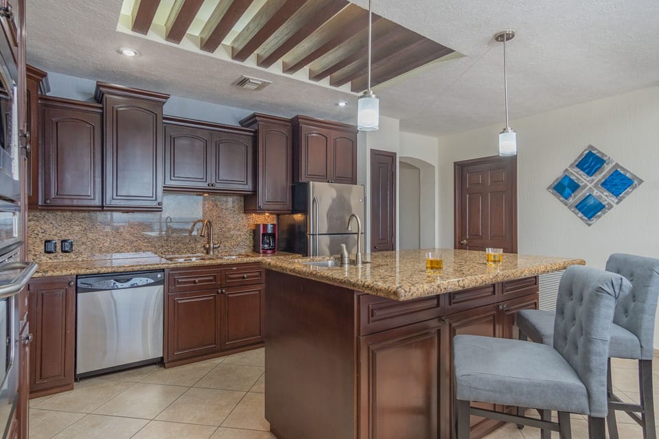The kitchen has an island and additional seating.