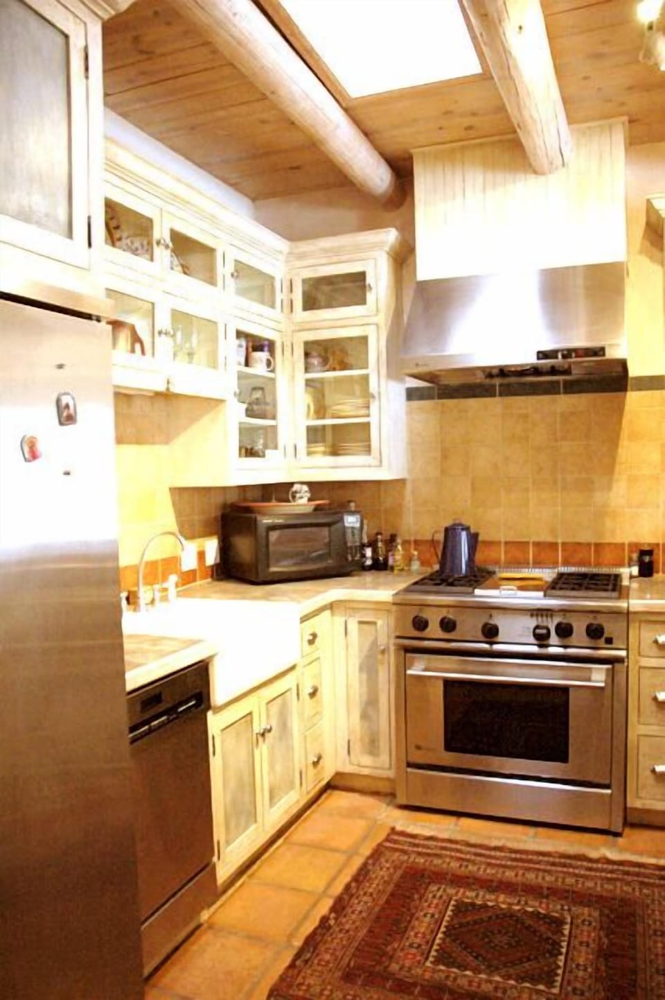 Light bright kitchen with sky light, gourmet Wolf oven/range, upscale appliances