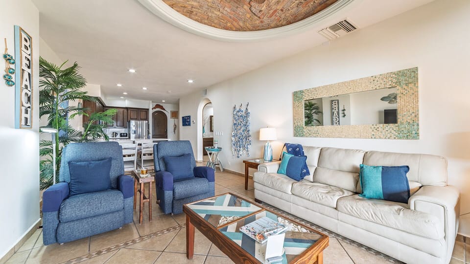 The living room invites with its sofa and twin recliners.