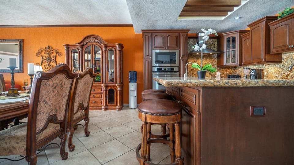 A kitchen island with bars stools.