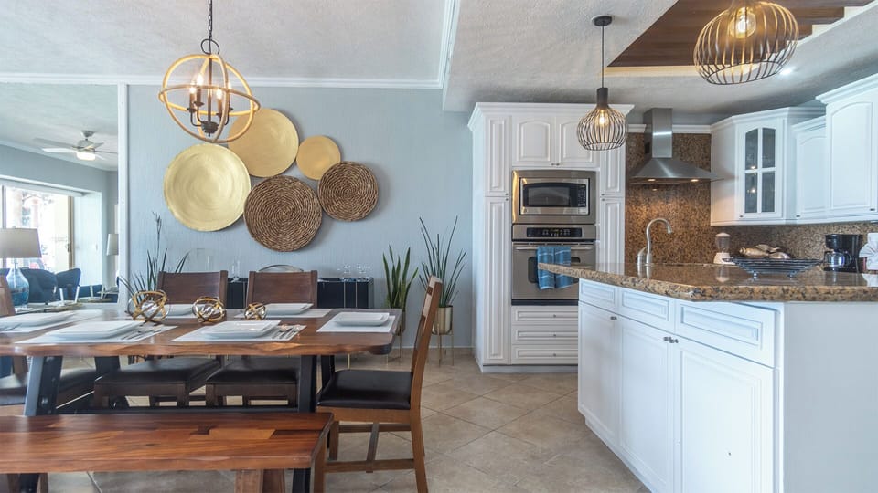 The dining table sits near the kitchen island.