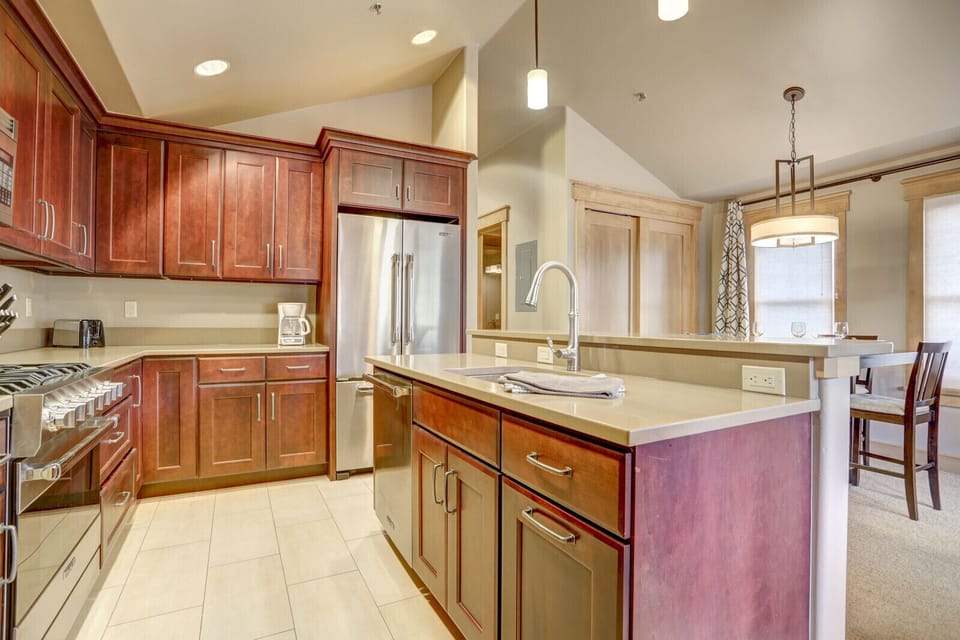 View of refrigerator and island into kitchen