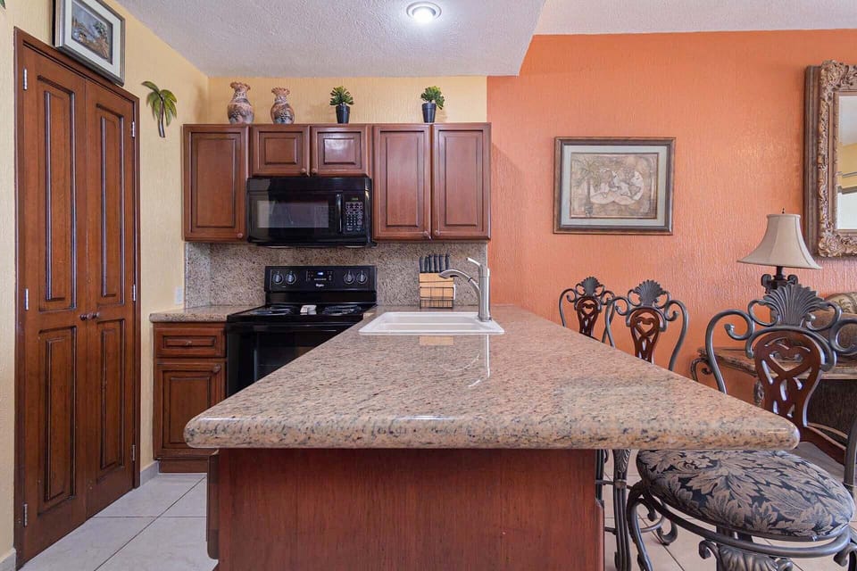 The kitchen with its large counter and seating