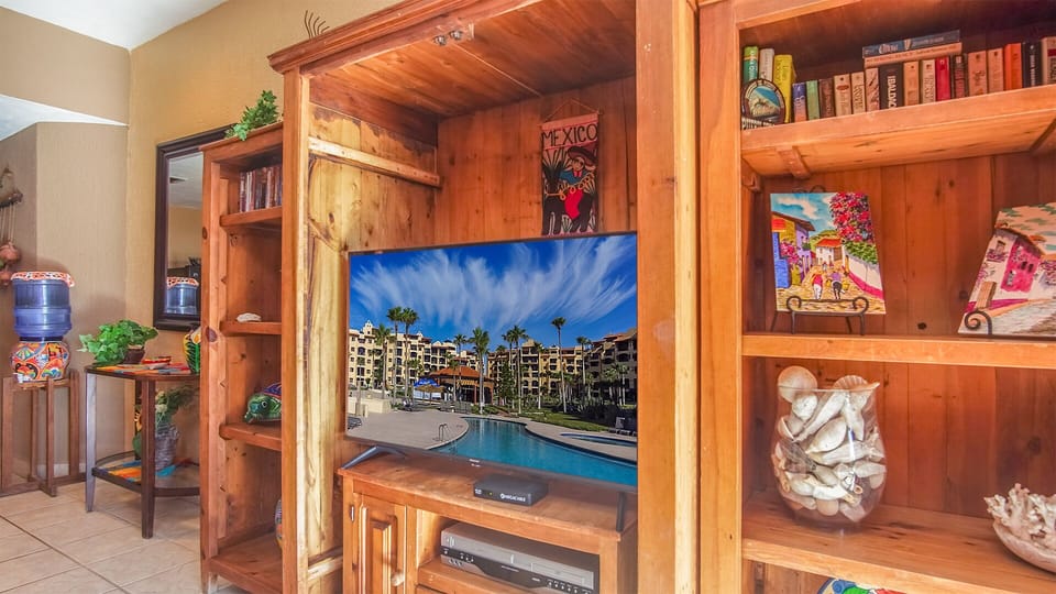 The TV sit on the large cabinet.