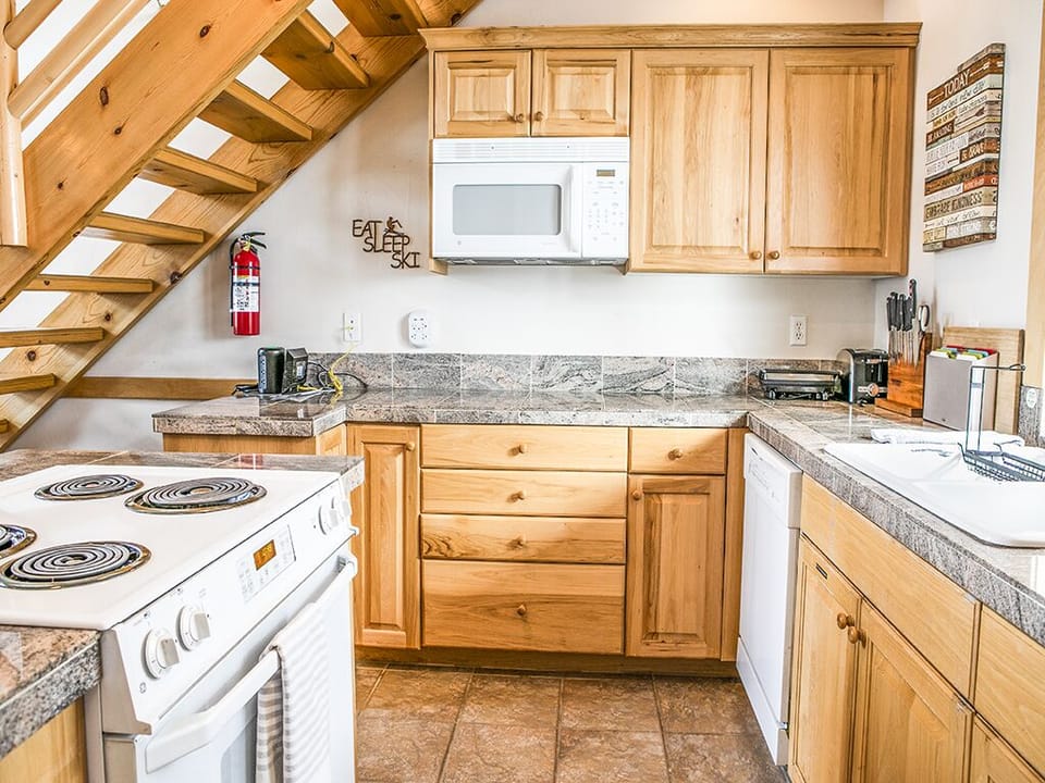 Kitchen is fully stocked! - Kitchen with stove and microwave with granite countertops