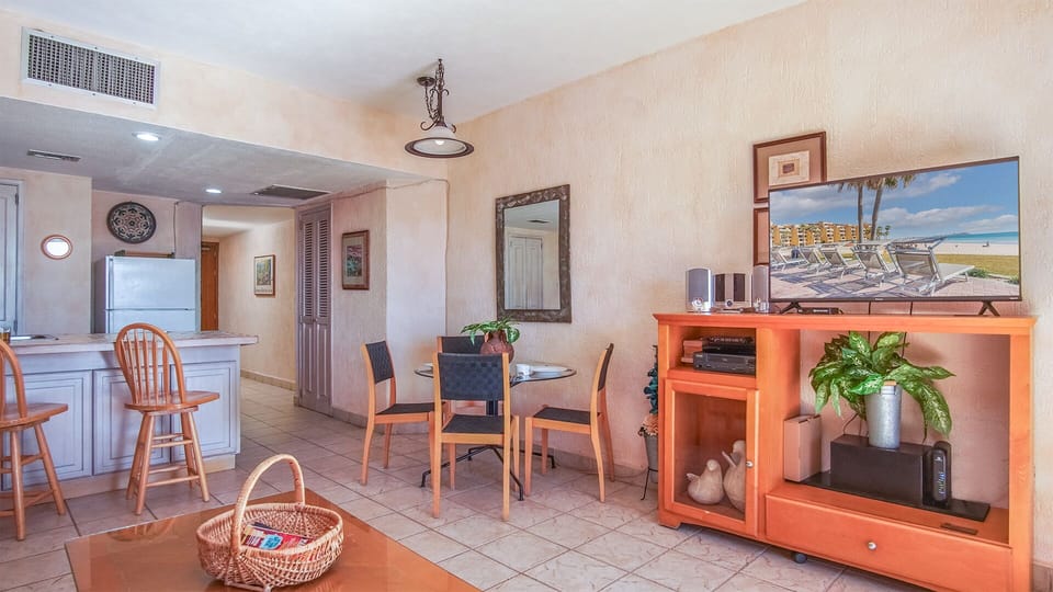 TV, entertainment center, and dining table.