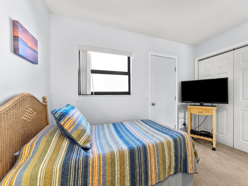 Cozy bedroom with vibrant linens and natural light