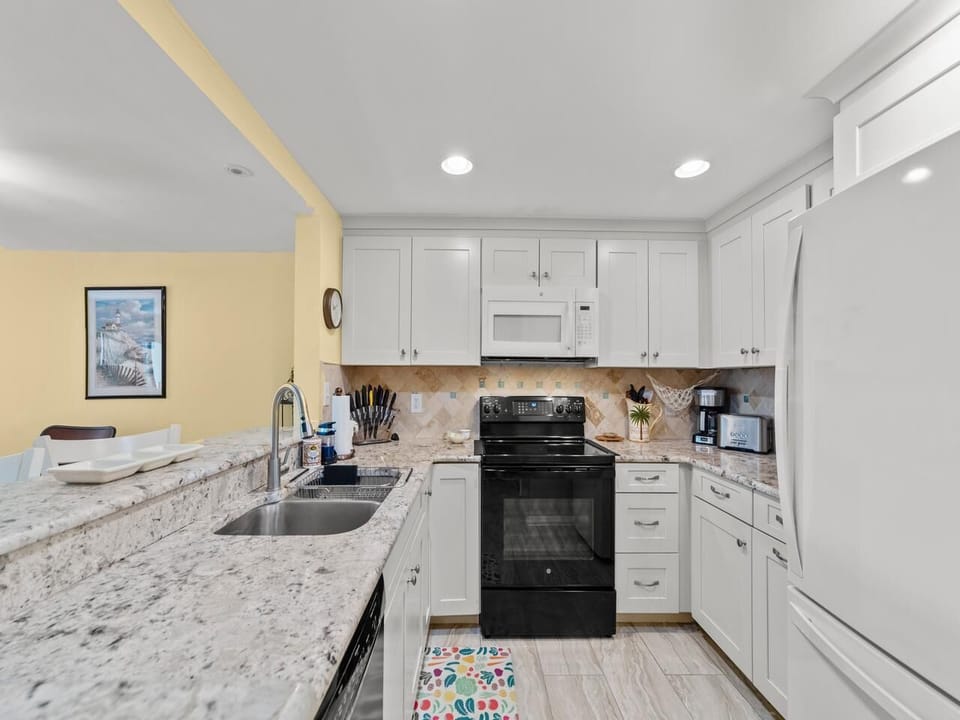 Bright, modern kitchen with granite countertops and ample storage