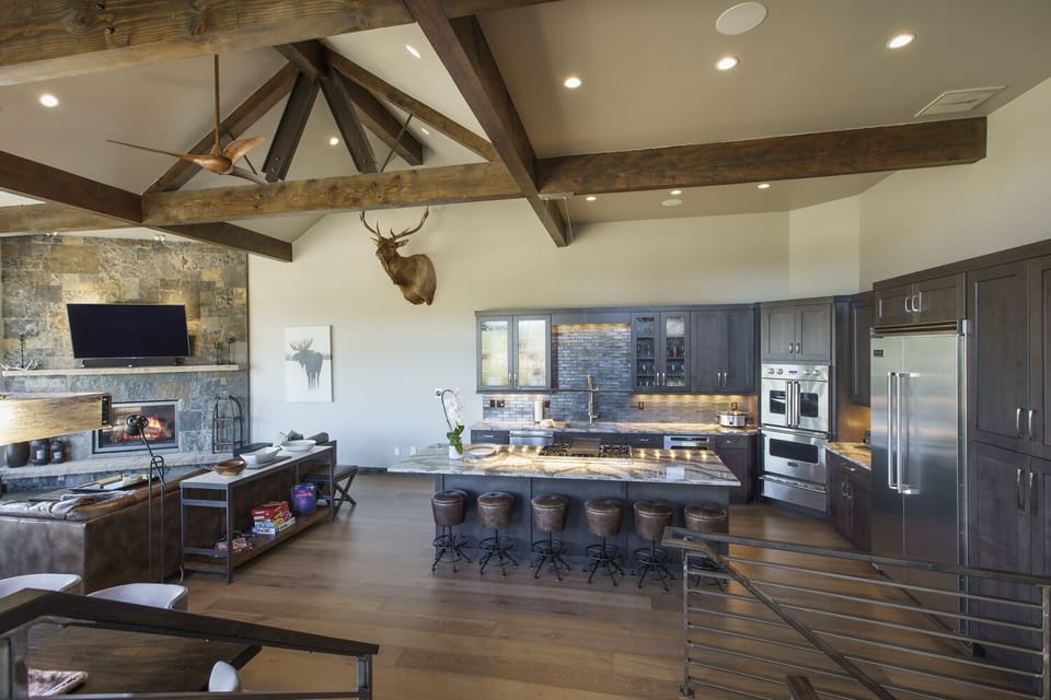 Looking down from the upper level to the kitchen, dining room, and living room
