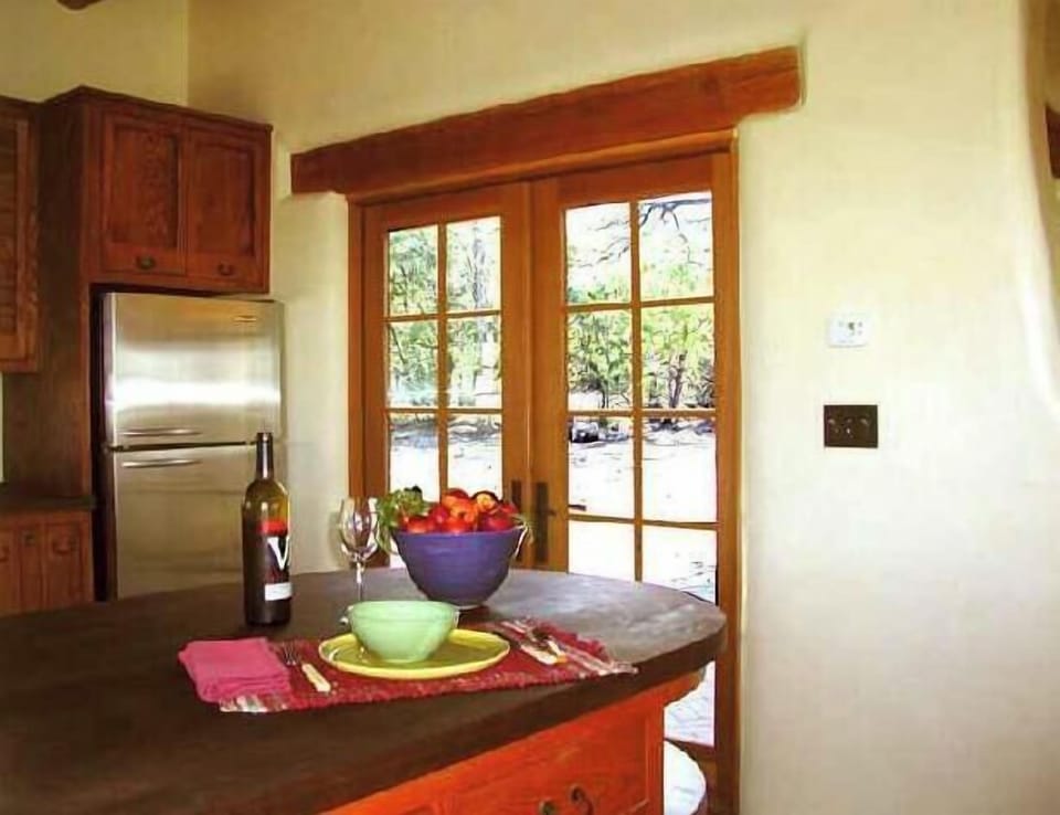 Kitchen serving bar, stainless fridge, French door walk out to wilderness