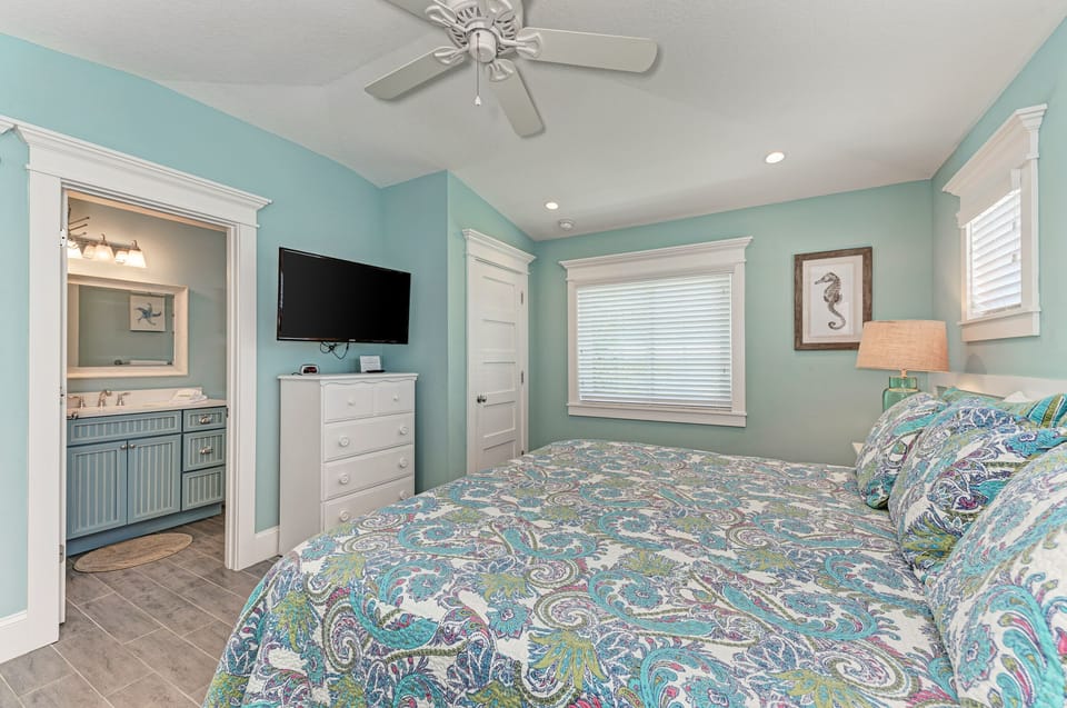 Master bedroom with en suite bathroom and TV