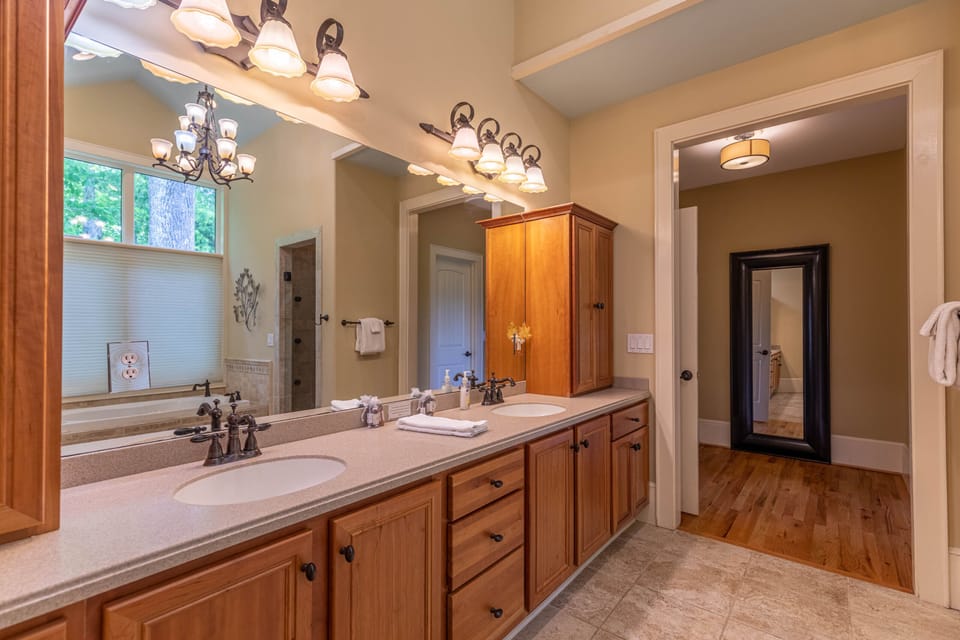 Plenty of counter space for everyone. The double vanity and warm wood cabinetry make getting ready feel effortless at Stags Leap At Yonahlossee.