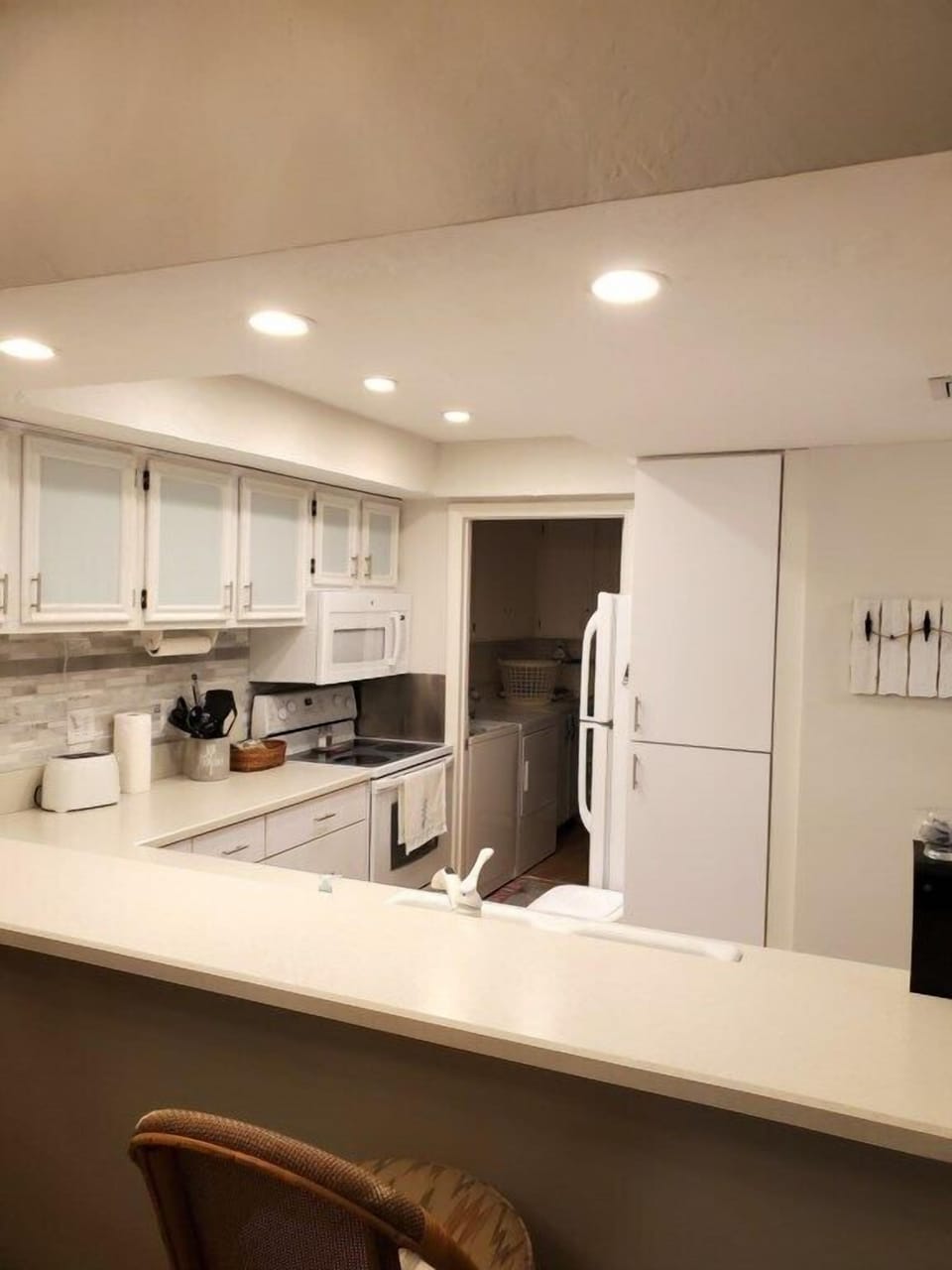 Fully-equipped kitchen with modern appliances and breakfast bar.