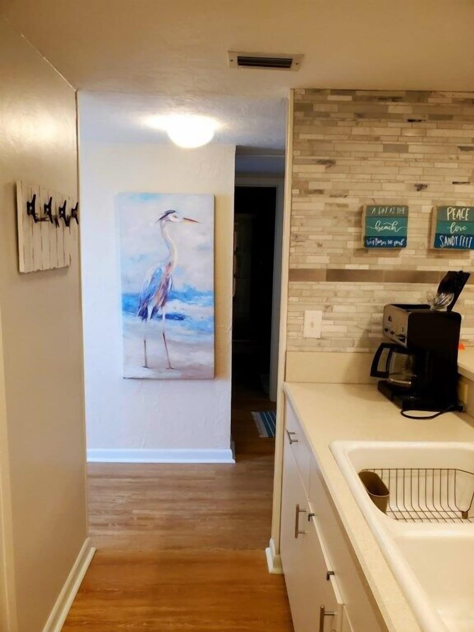 Charming kitchen with modern appliances and stylish brick backsplash.