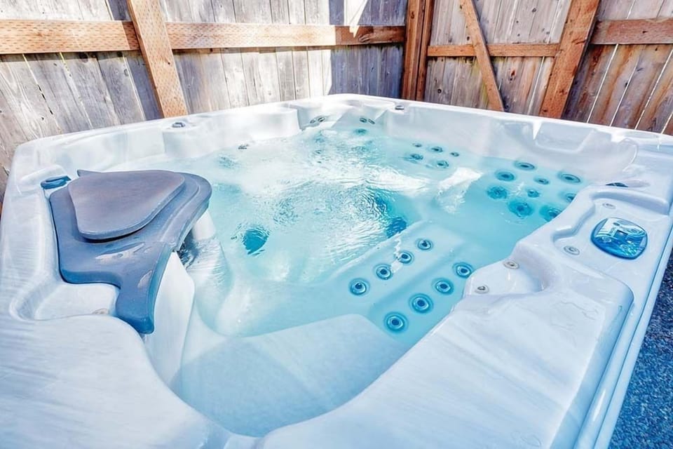 Relax in the private hot tub at Bloomer Mansion, your luxurious retreat for the perfect getaway.