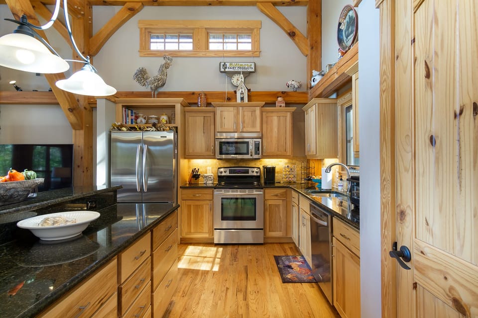 The kitchen features stainless steel appliances, granite countertops, and all the essentials needed to prepare home-cooked meals during your stay.