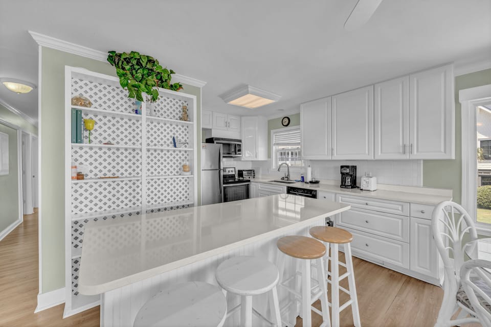 This bright, fully-equipped kitchen offers everything you need to prepare your favorite meals. Enjoy the open layout with sleek countertops, modern appliances, and plenty of cabinet space.