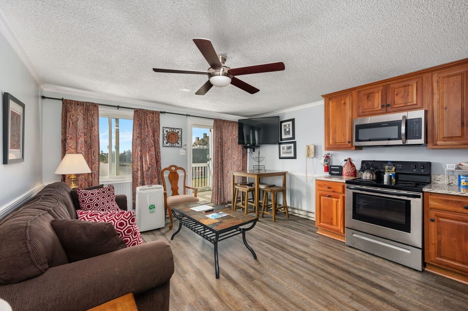 Relax and unwind in this spacious open-concept living area with a fully equipped kitchen.