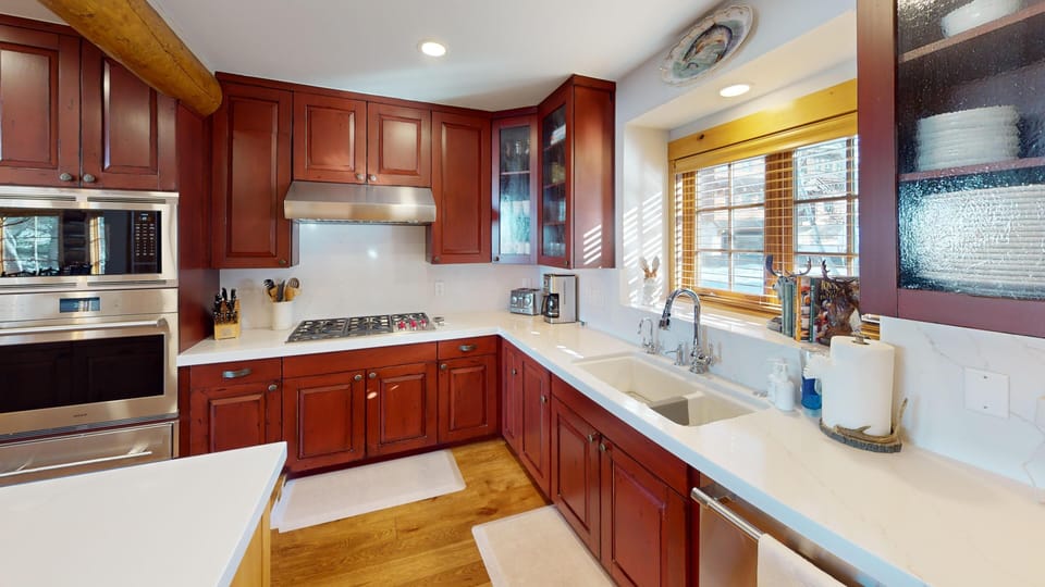 Your gourmet kitchen awaits with rich cherry cabinets, granite countertops, and professional appliances for memorable meals.