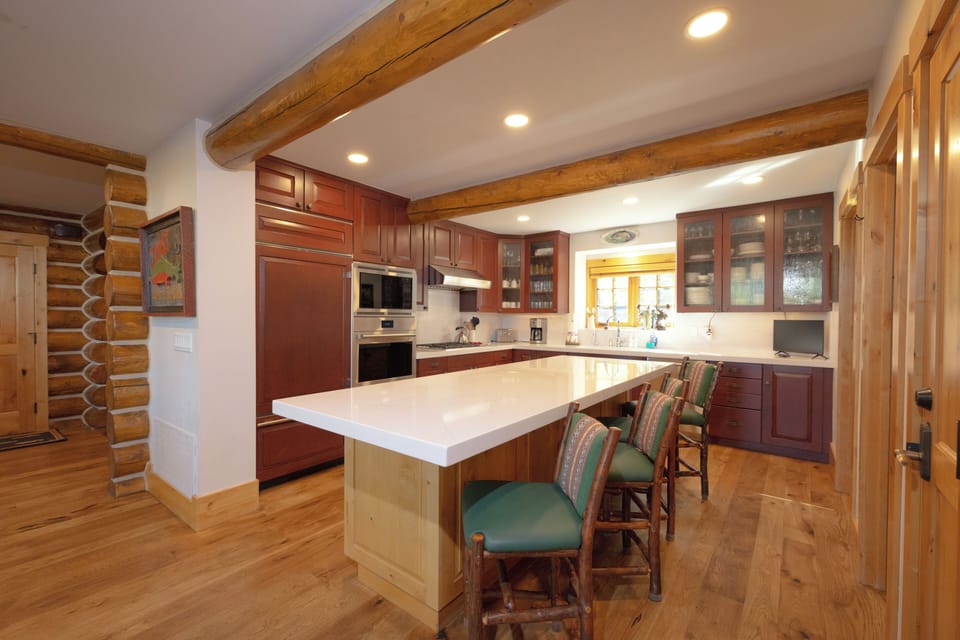Your spacious kitchen awaits with rich cherry cabinets, gleaming countertops, and a welcoming island where you can gather for morning coffee or evening meals together.