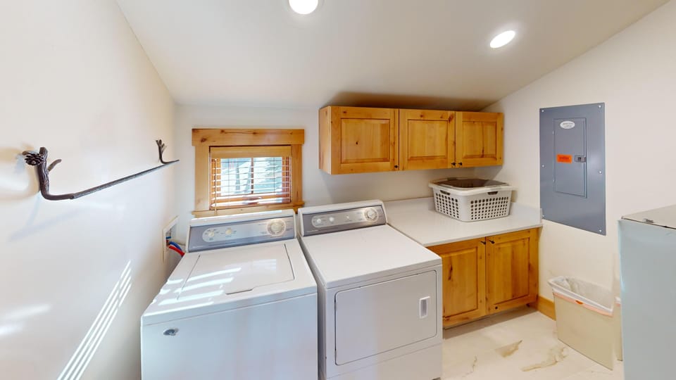 Your laundry stays fresh and organized in this dedicated utility room with full-size washer, dryer, and plenty of storage.